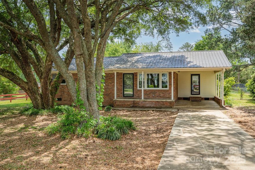 This delightful 3-bedroom, 1-bath home blends comfort, character, and practical updates. Step onto the inviting covered front porch and into a light-filled interior featuring an open kitchen and dining area—ideal for both daily living and entertaining. All three bedrooms showcase beautiful hardwood floors, and the bathroom is enhanced with stylish shiplap accents.

The living room offers a cozy and welcoming atmosphere, while thoughtful upgrades like on-demand gas hot water, updated replacement windows, and a durable metal roof add peace of mind. Outside, enjoy a fully fenced backyard with a convenient storage building, plus an attached one-car carport with private entry into the home.

With a location that offers easy access to major highways and nearby cities, this home delivers the perfect combination of charm, functionality, and convenience.