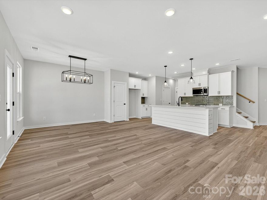 Discover the ease of low-maintenance living in this brand-new Thornhurst II townhome, just minutes from the charming shops, restaurants, and vibrant atmosphere of historic downtown Waxhaw! Embrace a lock-and-leave lifestyle with included lawn care, giving you more time to explore or relax in your private backyard. Spend weekends enjoying unique boutiques and local events, knowing your yard is maintained. Your backyard is a peaceful retreat with views of gorgeous trees and natural areas. This spacious home features an open, bright floor plan—perfect for entertaining or unwinding. The modern kitchen includes sleek quartz countertops and a large island overlooking your covered porch. After a long day, relax in the luxurious Owner's Retreat with an oversized walk-in closet. A side-by-side two-car garage and full driveway offer ample parking.