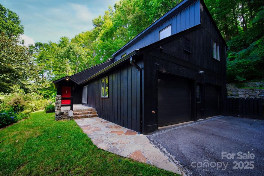 ~ SELLER OFFERING 2-1 BUYDOWN ~ ** Potentially saving qualified buyers hundreds of dollars per month during the first two years of homeownership!! ** Modern mountain living in this beautifully updated retreat, nestled in a lush, wooded setting just got more affordable!! The striking exterior features dark wood siding, stone accents, and large windows that blend seamlessly with the natural landscape. Inside, a dramatic great room boasts vaulted ceilings, skylights, and a floor-to-ceiling stone fireplace. The open layout is perfect for relaxing, hosting guests, or entertaining. The kitchen has been updated with granite countertops, stainless steel appliances, soft-close cabinetry, and designer finishes. Enjoy wide-plank hardwood floors, custom lighting, and thoughtful design throughout. Professionally landscaped grounds include mature trees, flowering shrubs and natural stonework. This property offers comfort, privacy, and style—conveniently located near vibrant Asheville.