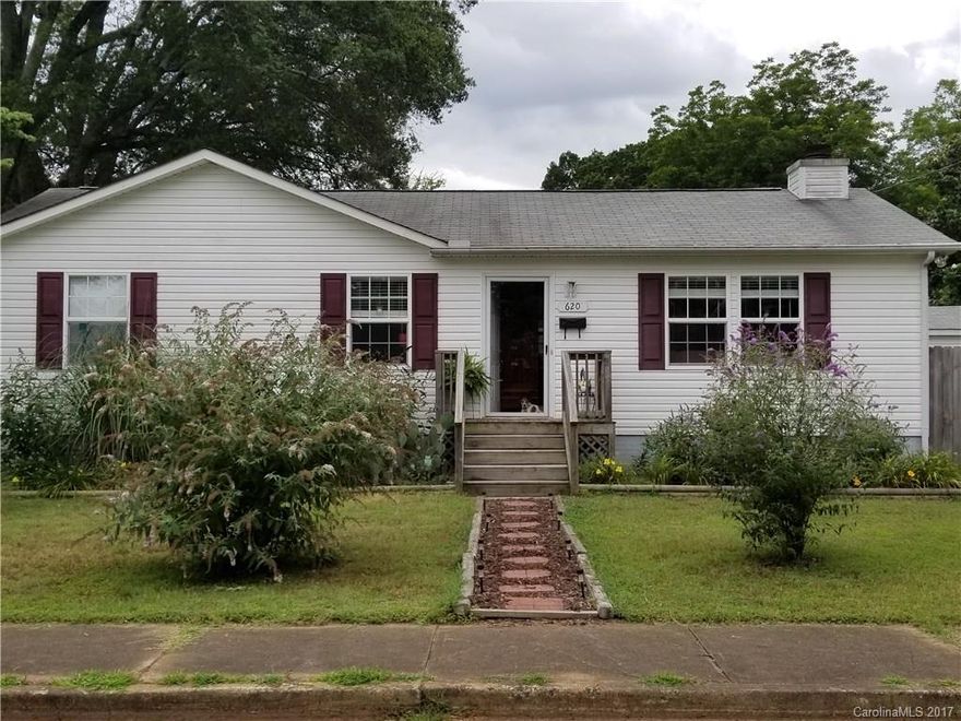 Come home to this cozy & updated 3 BR Ranch near Downtown Rock Hill. Wood burning fireplace in family room.  Kitchen has dining area + bar overlooking great room. Refrigerator conveys. Laminate wood flooring throughout. Corner lot close to area amenities. Spacious screened porch & privacy fenced back yard. Outbuilding has electricity and cable. No HOA.