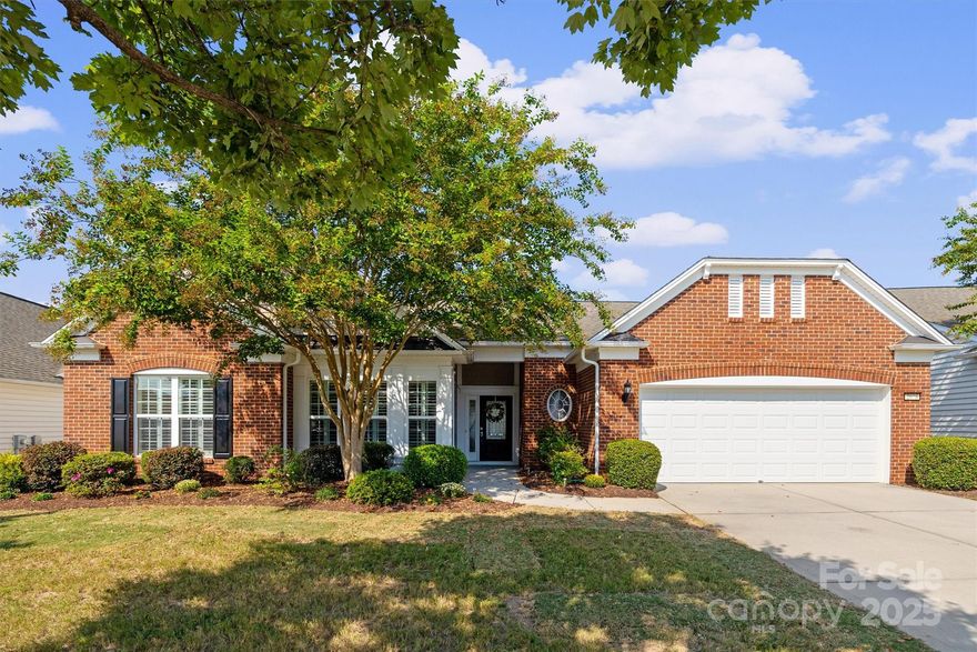 As you step through the front door, you'll immediately feel the warmth and charm of this meticulously cared-for home. The open floor plan is complemented by beautiful pre-finished hardwood floors that flow seamlessly throughout. Wainscoting and Plantation shutters add to the charm. 
 The heart of the home is the stunning gourmet kitchen, which boasts granite countertops, center island, and breakfast area. A built-in desk to organize your daily tasks and seamless access to your private, landscaped backyard, which makes entertaining a breeze. 
Gather for special occasions in the elegant formal dining room, where a cozy fireplace creates the perfect ambiance. Find a quiet retreat in the sunroom or work productively in a dedicated office featuring classic French doors.
Primary bedroom is a true sanctuary, highlighted by a dramatic trey ceiling, Primary Bath offering a luxurious soaking tub, a separate walk-in shower, double sinks, and a large walk-in closet.
Step outside to discover your own Private Oasis. 
The backyard is an entertainer's dream, featuring a large paver patio with a stylish sitting wall and a unique Circular Platform. The space is beautifully framed by mature trees and seasonal flowers, all overlooking a tranquil open space—providing a sense of peace and privacy that is hard to find.
Living Sun City Carolina Lakes is like being on Vacation all Year Long. It is surrounded by a Public Golf Course with two Large Amenity Centers/Three Pools/ 3 tier Fitness Center,/Tennis/Pickleball/Bocce/Walking trails, a Baseball Field, and Lake Access for Kayaking. Over 150 Clubs, something for Everyone at an Affordable Price.