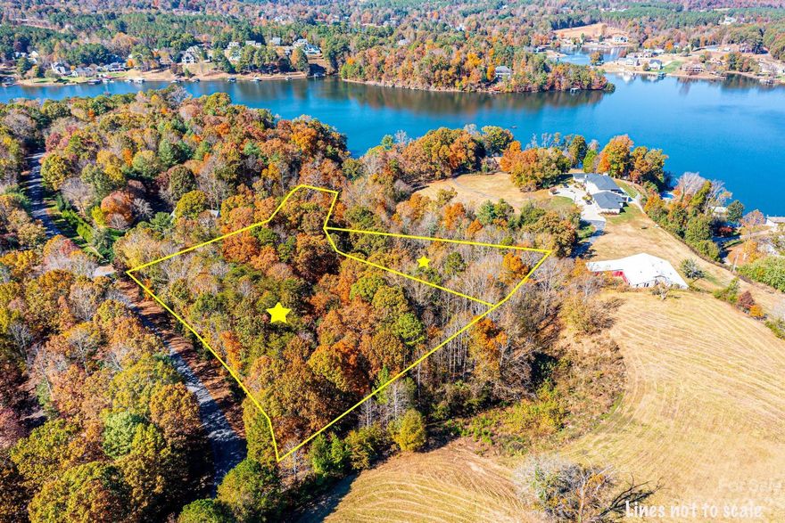 Incredible opportunity to build your custom home in prestigious NW Hickory Location. This 4 acre tract features a large, corner presence with approx 45' on Lake Hickory. This cove lot offers big views of the main channel.  Laurel Ridge offers large private lots with beautiful custom homes. No city taxes! Minimum heated sq ftg of 3,000.