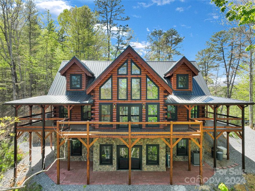 Welcome to this brand new log home retreat, perched on the edge of pristine Fontana Lake in the Smoky Mountains. The log home is a picture of rustic elegance, with large windows that invite the outdoors in. The warmth of a fireplace casts a glow over the open-concept living space. Vaulted ceilings with exposed beams soar overhead and open to the loft. The kitchen is a chef's dream, featuring modern appliances with a large breakfast bar providing ample prep space. In the master suite, a ensuite bathroom beckons with a deep soaking tub and walk-in shower. Two additional bedrooms with baths on upper level with a open loft.  The 3-sided deck offers the perfect spot to sip your favorite beverage.  A path leads to the lake ready for your private dock. For game time, enjoy the large family room with fireplace in the lower level, as well as an office and full bath. Located in the only gated lake community on the unspoiled, 28 mi long Fontana Lake which borders the GSNP. Motivated Seller!