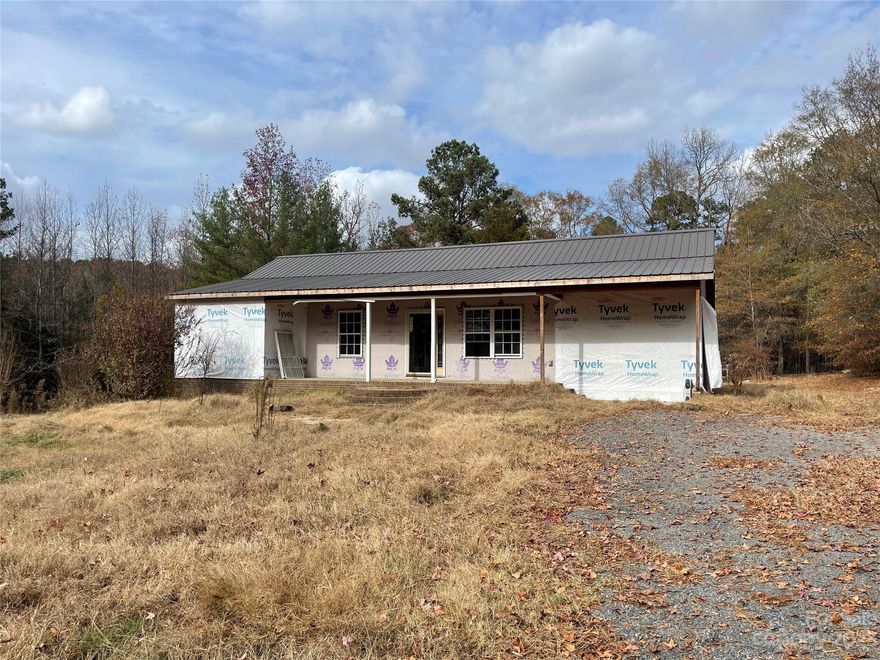 Home is framed and ready to be finished by the new owners! Located off of Hwy 24/27, you will love the privacy of the setting. Great layout with open living room/kitchen. Chimney fire damaged the roof.  New trusses were added as well as new metal roof, spring 2022. Flooring, drywall, etc removed in most areas after the fire.  Plumbing and wiring in place but not in working order. No known damage to the framing of the home. Bring your contractor and make this house a home!
Long gravel driveway to house. Driveway sits to the right of larger home at 20509.