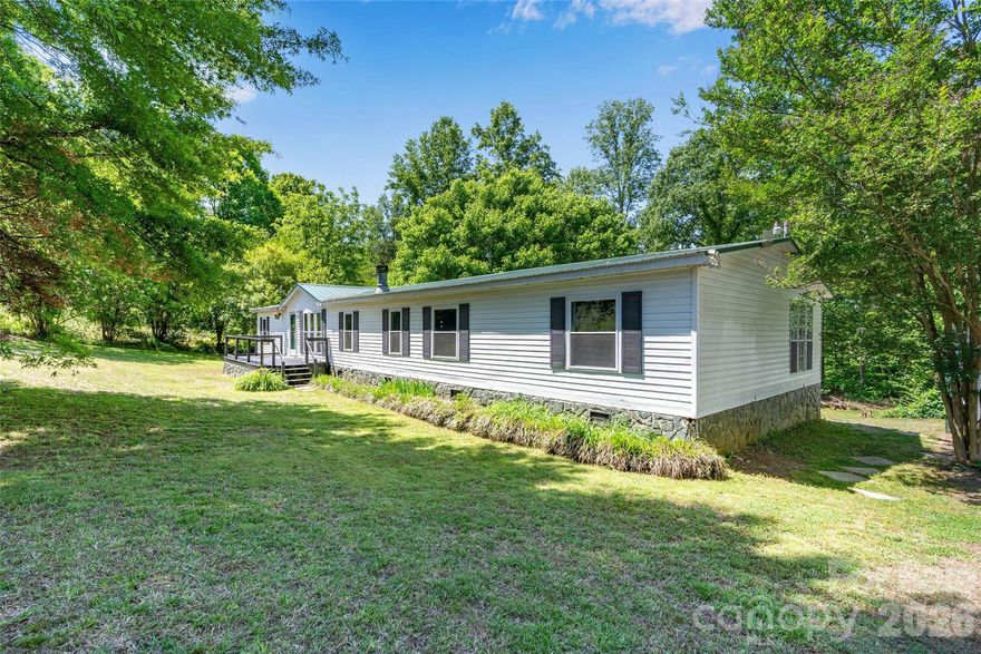 WHOA, this one is priced to sell!!!! 2.6 acres, right at 2,000 sq ft, 3 bedrooms with a bonus/flex room, and a 2-bay metal garage!!! If you are looking for space on a budget THIS IS IT!  There is nothing else in Denver with 2 + acres even close to this price point. This home has been partially renovated with both bathrooms completed, new flooring and lots of upgrades/replacements to the home. New metal roof in 2014, new hot water heater in 2024, new well tank in 2024, household water filtration system installed, and the decks have been refreshed and renewed. The owner's suite is huge and is situated on its own side of the house. The owner's closet is the size of a small room, and the ensuite bathroom... so very cute with its rustic renovation. Like spending time outdoors, the back deck is sure to bring pleasant times either enjoying your morning coffee or grilling out in the evenings. The space here is plentiful and the layout of the home lives comfortable, you truly must tour to appreciate. If you have large work vehicles, there is plenty of room here to park and store them. While there have been some renovations completed there is still TLC needed in areas that you could do yourself to build sweat equity.  Wonderful location, great schools, close to everything... dining, grocery, gas, etc..  Don't wait tour today!