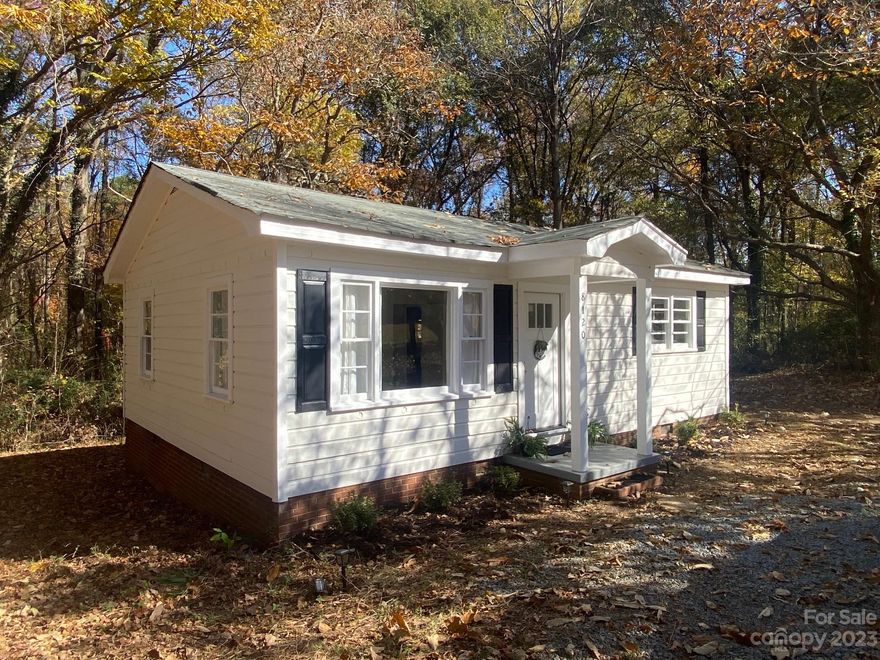 **Back on the market**  Previous buyer's loan fell through.  A fabulous affordable opportunity awaits to own this mid-century classic Charlotte Bungalow, conveniently located near Mt. Holly Road and I-485.  Close to the Whitewater Center, Charlotte-Douglas Airport, or a quick commute to Uptown Charlotte. Recent cosmetic updates include flooring, fresh paint, wall insulation, an updated full bathroom and fresh gravel for the driveway. City water and a private septic system, with possible access to city sewer, tap fees apply. The gravel road from Hugh Caldwell Rd. to the home is a private road with no known maintenance agreement. No HOA.