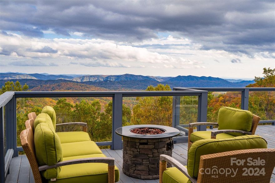 The perfect retreat, full-time residence, or investment property w/ long-range, layered Gorge & Blue Ridge Mtn views resting on 11.3+ acres of wooded privacy. This 3BR 4.5BA home (w/ bonus rooms/spaces) offers a quiet setting & central location to Boone (20 min), Blowing Rock (15 min), & all the High Country has to offer! Short-term rentals allowed=vacation rental potential! The spacious great room features window-lined walls for taking in the views & gas fireplace & wet bar, & is adjacent to the dining area & kitchen w/ fireplace, granite counters, & kitchen island. Enjoy the mountain views (w/ Sunrise views to the East) from the large deck or large, covered, wrap-around front porch. Main level also features addt'l living room/den & bonus room/office currently set up as a BR, half bath, & entrance foyer. On the second level, find a landing area/reading nook, three BR/BA suites incl. the primary suite w/ gas fireplace, bonus room currently used as a BR, additional full bath, & laundry.