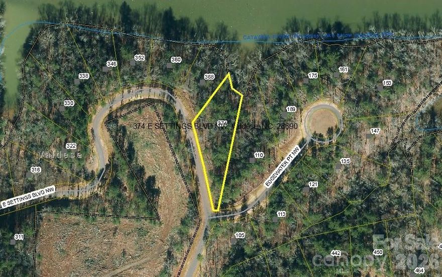 BEAUTIFUL WATERFRONT LOT in the GATED COMMUNITY of LAKE RHODHISS ESTATES.  Enjoy the view across the lake on this private, gently sloping lot that is perfect for a walk-out basement home.  Build your dream home or the family vacation destination that you’ve always wanted.  Enjoy launching your canoe, kayaks and other paddle craft just steps from your back door.  If you’re looking for a boat launch, this community has a private, gated lake access just down the road, complete with private dock, fire pit and picnic areas.  A perfect place to spend the day.  Or, entertain friends and family at the community overlook where the rooftop deck offers stunning views.  Grilling area underneath has casual seating, dining area, a grill/food prep area and restroom.  Water and sewer tap available at the street, all utilities are underground.