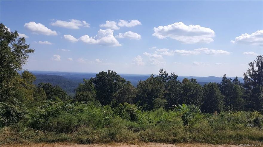 Enjoy spectacular, long range, panoramic views from this .62 acre wooded, mountain top building lot consisting of two combined parcels. Rural and private yet conveniently located in Valdese NC within 3 miles of the I-40 corridor between Hickory and Morganton.