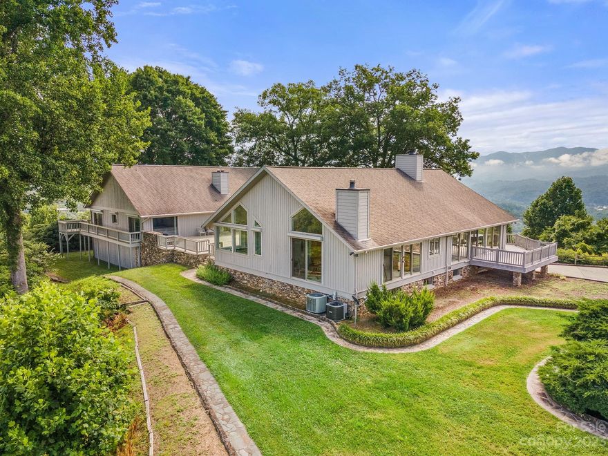 Immerse yourself in unparalleled luxury with 360-degree panoramic mountain vistas from an elevation of 2,430 feet, situated just minutes from downtown Bryson City. This secluded sanctuary offers 360 breathtaking views stretching across Bryson City, Cherokee, Mt Noble, GSM National Park, to the Tennessee state line. The capacious home, exceeding 7000 sq. ft. of heated living space, features a west wing adorned with cathedral ceilings, floor-to-ceiling windows, and high-end finishes. The east wing offers a rustic cabin ambiance, replete with wooden ceilings, a stone fireplace, a full kitchen, and a multitude of bedrooms. Separate entrances facilitate potential rental opportunities, with each room delivering stunning views. Bonus features include a billiards room, an exercise/dance room, a four-car garage, and ample storage space for treasured possessions. Matterport 3D tour available.