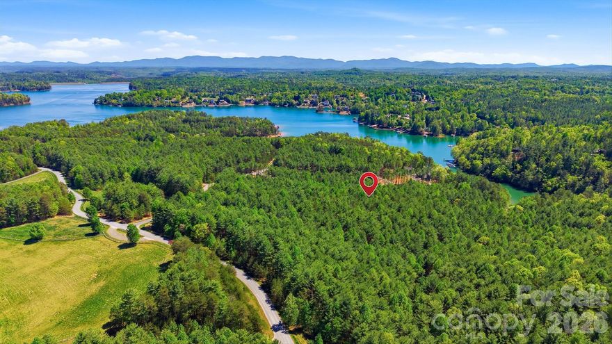 One of the most private and versatile homesites in Old Wildlife Club at Lake James. Spanning 4.34 acres, this property offers a rare chance to build a secluded retreat along a hidden ridge, bordered on the north and west by over 13 acres of protected community conservation land and beautifully hidden hiking trails. A long, winding driveway can guide you through native hardwoods and mountain laurel to an ideal build site, well-suited for a primary residence, guest cottage, or a thoughtfully designed compound. Architectural standards ensure lasting quality, while the absence of a minimum size requirement gives you the flexibility to build according to your vision.
The property includes a deeded community boat slip with a new, heavy-duty boat lift (valued at over $12,000), providing convenient access to Lake James. Owners also enjoy scenic community trails and membership at Camp Lake James, a premier lakeside adventure center offering a wide range of amenities and activities.