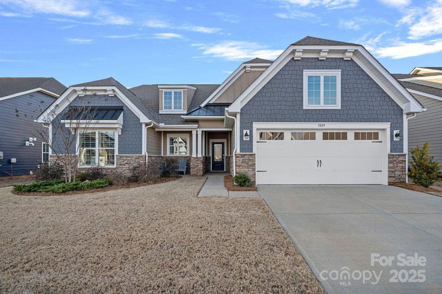 This beautifully finished Elmont plan backs up to a private wooded area. Open floor plan features extensive crown molding, upgraded light fixtures and fans. The upgraded kitchen has double ovens, a gas cooktop, pull-out drawers and undercabinet lighting. It opens to the dining area and the Great Room with a gas fireplace.  Primary bedroom overlooks the tranquil backyard. Two bedrooms are on the opposite side of the home with a full bathroom. Excellent storage throughout, including custom closet systems, solid pantry shelves, and a large storage closet. Epoxy floor in the garage. The paver patio is a great place to entertain and enjoy the peaceful backyard. Tree Tops is a gated community with low SC taxes, close to shopping, restaurants & more! Neighborhood clubhouse, outdoor pool, pickleball and tennis courts, walking trails, dog park, kayak launch & lake access. Plus, there are several cabins with activities for everyone including arts and crafts, games & a fitness center.