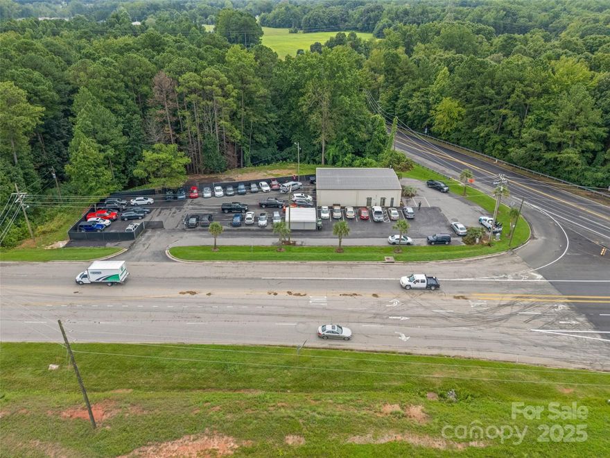 High-visibility corner lot located at the intersection of Black Highway and Alexander Love Highway in York, SC. Currently leased to an auto service business, this investment property offers both immediate cash flow and strong appreciation potential in a rapidly growing community.

This steel frame, flex-space building features 650 sq. ft. of finished, air-conditioned office space with two bathrooms.  Plus 1,750 sq. ft. of tall-ceiling warehouse/workshop space which also is climate controlled. Outside, you’ll find a large fenced parking area (approx. 1/3 acre) along with additional parking surrounding the building. The property sits on a 2.6-acre lot with room to expand, making it ideal for future growth.

Conveying with the sale are one car lift, an air compressor, and a covered carport inside the fenced area.

This location is just minutes from downtown York, with new neighborhoods, shopping, and schools nearby—making it a sought-after site for businesses or investors.
