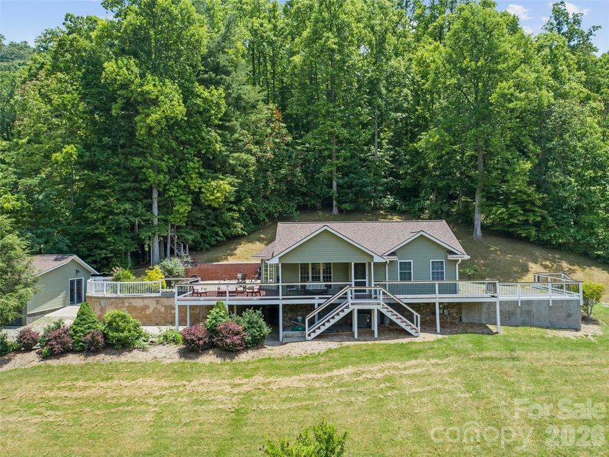 Discover unrivaled privacy in this private 2BR, 2BA mountain home, gracefully situated on 17 sprawling acres near Barnardsville, less than 30 minutes from Asheville. Wake each morning to the beauty of the fog rolling through the valley. This home offers comfortable living with a finished basement—perfect for guests or a recreation room. Enjoy morning coffee from the treehouse deck or evening gatherings on the expansive patio to marvel at a starry sky uninterrupted by city lights. Explore multiple ATV trails to discover private camping sites and a cleared ridgetop with a wildlife food plot for the deer and turkeys that meander through the yard. Adventure is at your fingertips with Navitat, Pisgah National Forest, and the Blue Ridge Parkway all just a short drive away. This property offers total mountain solitude and a place to create lasting memories in the heart of WNC. Don’t let this mountain sanctuary pass you by—schedule your private tour today and experience the serenity for yourself!