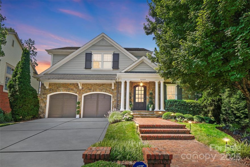 Custom Simonini waterfront home beautifully modernized and remodeled in recent years for elegant lakeside living. This 4 bed, 4.5 bath residence offers an open-plan main level with a fireplace-lit living room, gourmet kitchen, and breakfast area overlooking Lake Norman. Large sliding doors open to a covered porch with fireplace and motorized screens. A formal dining room with wet bar adds to the elegance. The main-level primary suite features lake views, a luxurious en-suite, custom closet, and private laundry. Upstairs offers three spacious en-suite bedrooms, a luxe laundry room with floor-to-ceiling cabinetry, and a dedicated home office space. Outside, enjoy a built-in top-tier grill, lush landscaping for privacy, and your deeded boat slip is literally just steps away. Closest house to the deeded slips!  Considerable storage throughout, plus a large 2-car garage with built-ins. This is a rare opportunity to enjoy refined waterfront living in the sought-after Captain’s Point community.