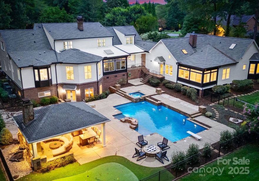 Exceptional Two-Home Estate on 2+ Acres
In a private enclave of seven homes, this rare dual-residence estate blends privacy, elegance, and convenience. This renovated residence offers 7,600+ sq ft with a main-level primary suite, large family room, multiple fireplaces, hardwood floors, and a gourmet kitchen with gas appliances. Walkout basement perfect for entertainment.
Outdoor living shines with a pool/spa, putting green, fire and water features, wood-burning fireplace, outdoor kitchen (grill not built-in), True fridge drawers, two beer taps, and Rachio smart irrigation. Expansive windows and screened porches invite stunning views of the manicured grounds.

The 2005 guest house includes 2BR + bonus, 1.5BA, full kitchen, sunroom, and 2-car garage. Both homes feature sealed crawl spaces with dehumidifiers; guest house has full generator powering select main house items. James Hardie siding, newer windows, well with filtration, city sewer, and private retreat minutes from SouthPark.