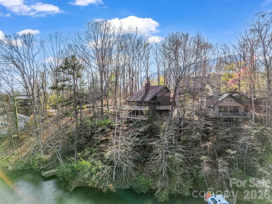 Waterfront Home, Private dock, Rare opportunity!
Step into this fully furnished lakefront retreat inside the gates of Rumbling Bald on Lake Lure — where life slows down, and classic lake life takes center stage. Overlooking Bald Mountain Lake and the Blue Ridge Mountains, this home invites you to enjoy simple pleasures like sunrise coffee on the deck, evenings spent playing board games, and peaceful moments by the water.

Designed for relaxed, easy living, the main level features a cozy living/dining area, primary suite, full bath, laundry, and access to a wraparound deck that feels like an extension of the outdoors. Upstairs offers two guest bedrooms, a second full bath, and a quiet sitting area—perfect for reading, puzzles, or unwinding after a day on the lake.

The lower level is built for fun and connection, featuring an entertainment room with air hockey, board games, and movie-night space, along with a half bath and direct lower-deck access to your private dock and the non-motorized lake—ideal for fishing, swimming, paddleboarding, or kayaking.

Full of character and timeless appeal, this home embraces the charm of a classic mountain lake retreat—comfortable, inviting, and centered around enjoying the outdoors, the water, and time together. With a proven history as a successful short-term rental, private water access, and access to Rumbling Bald’s golf, private beach, Wellness Center, and dining, this property offers a rare opportunity to own a lake home that truly feels like a getaway.

Location is exceptional! Just a short walk or golf-cart ride to Bald Mountain Golf Course, the beach, Wellness Center, and restaurants—lake lifestyle and convenience in one charming package.