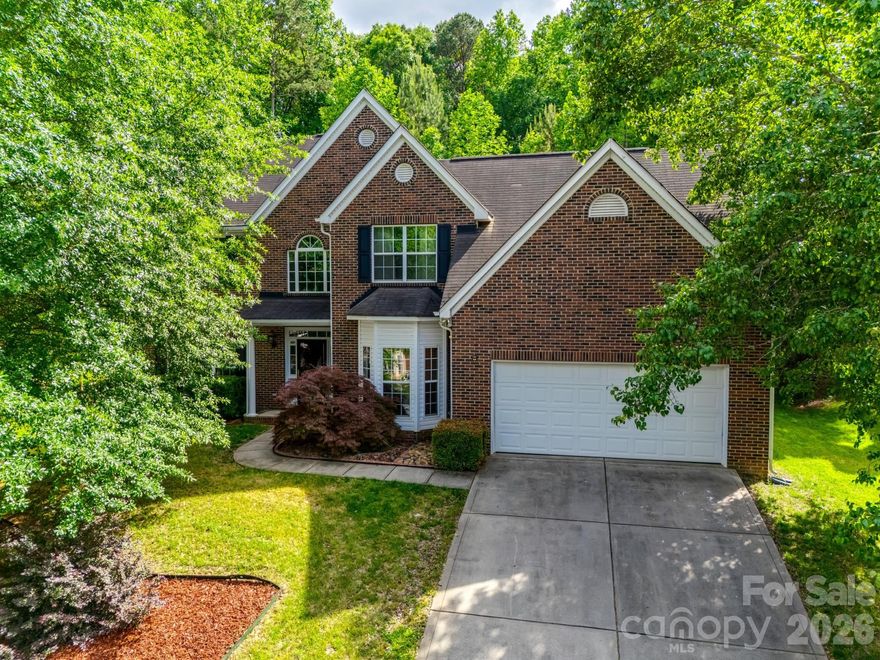 Welcome to this beautifully updated Huntersville home, offering 5 bedrooms and 3 full bathrooms on a private 0.58-acre lot. With 2,860 sq ft across two stories, this home features a spacious layout perfect for everyday living and entertaining. The main living room showcases vaulted ceilings and a cozy gas fireplace, while a separate family room includes a modern electric fireplace. The primary suite offers a private en suite bath and large walk-in closet. Recent updates include a reimagined kitchen with new appliances, updated tile flooring throughout the main living areas, and modern lighting through the home. Outside, the property truly shines. The sloped lot offers exceptional privacy, while two separate flattened yard areas behind the home providing versatile outdoor spaces—ideal for entertaining, play, or enjoying nature. With its blend of recent upgrades, generous living space, and a rare, private lot, this home delivers comfort in a beautiful Huntersville neighborhood