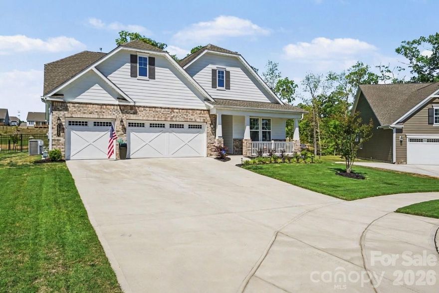 Welcome to lake living at its finest at 8027 Longwaters Court, located in the highly desirable, gated 55+ community of Gentry at Handsmill on Lake Wylie. Nestled on a larger lot in a serene cul-de-sac, this single-story home offers peaceful lake views and a lifestyle centered around relaxation, recreation, and low-maintenance living. Residents have the option to rent boat slips, jet ski slips, kayaks, and boat storage through two private marinas, one of which includes a boat launch, as well as HOA-maintained lawn care for effortless living. This exceptional 3-bedroom, 3-bath residence features a flex room currently used as an office but ideal for hobbies or additional living space, a 3-car garage, over $40,000 in structural options, just under $100,000 in design center selections, along with over $100,000 in post-closing upgrades throughout the popular Mulberry floor plan. Designed for elevated living, the open-concept layout showcases luxury EVP flooring in French Oak tones and a gourmet kitchen with quartz countertops, a custom designer range hood, and a walk-in pantry. A dramatic floor-to-ceiling stone gas fireplace anchors the main living area, complemented by refined details such as a coffered tray ceiling and upgraded designer lighting. The extended living room and sunroom enhance natural light and everyday comfort, creating seamless spaces for both relaxing and entertaining. The fenced backyard features an expansive deck overlooking Lake Wylie, making it perfect for morning coffee or evening gatherings. The owner’s suite offers a spa-inspired bathroom with a deluxe walk-in shower and a custom-designed luxury closet. Secondary baths are thoughtfully upgraded, and the home is equipped with advanced electrical and smart home enhancements, including expanded Cat 6 data infrastructure, floor outlets, under-cabinet lighting, and full AV prewiring, making it ideal for today’s home office needs. Additional highlights include permanent exterior holiday lighting with more than 1,000 customizable patterns, offering effortless, year-round ambiance. Community amenities include a clubhouse with fitness center, swimming pool, splash pad, catering kitchen, and an event center currently being renovated to further enhance future gatherings and activities. More than a home, it’s a luxurious Lake Wylie lifestyle, where comfort, connection, and elevated design come together.