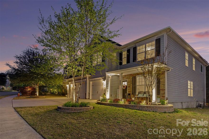 Welcome to Lake Ridge in Tega Cay!  This bright, spacious home has an open floorplan with thoughtfully designed spaces and a rare 3-car garage.  Hardwoods throughout the main floor living spaces, which include a formal living room and formal dining room with coffered ceiling and chair rail molding.  The kitchen features double ovens, gas cooktop, island, and rich cabinets paired with granite countertops and subway tile backsplash.  The cozy breakfast nook is adjacent to the screened porch and backyard.  The kitchen flows into the family room with beautiful built-ins and a stacked stone fireplace.  A private guest bedroom is also conveniently located on the main floor. 
Upstairs, there is lots of room to spread out, including a loft/landing that makes a perfect workspace, and a massive bonus/flex room.  The expansive primary suite features a sitting area, two walk-in closets, and bathroom with separate vanities, tiled shower, and garden tub.  There are 3 secondary bedrooms- one en suite, and two sharing a jack and jill bath.
Enjoy the beautifully refreshed landscaping and outdoor lighting! The fenced backyard features a screened-in porch w/ a lovely paver path and patio with stone fire pit, with a buffer of trees providing privacy and a peaceful backdrop.  Lake Ridge is a master-planned community with extensive amenities, including a pool with slide, multiple sports courts, walking trails, playground, clubhouse and fitness center. 
Neutral, tasteful finishes throughout the home will make it easy to move in and make it your own!