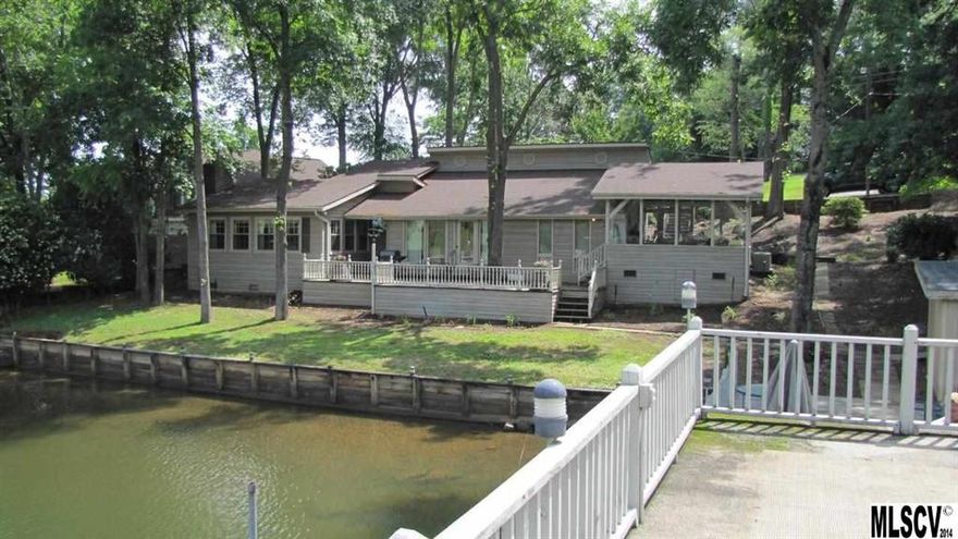 Walk out your back door onto Lake Hickory. Level lakeside .48 acre yard with 2 story dock on 150' waterfrontage. Home needs work but priced accordingly. Tri-level 3 Bedroom and 2 Baths. Sunken LR with wood-burning fireplace has separate entrance. Good sized bedrooms with lots of sunny windows. Enjoy the big views in the spacious sunroom with separate heat/cool system ('98) or on the deck overlooking a deep cove just off the main channel. Dock includes 2 boat slips with lifts and 2 sundecks. Boat house for lake toys storage. Seawalled. Irrigation system.