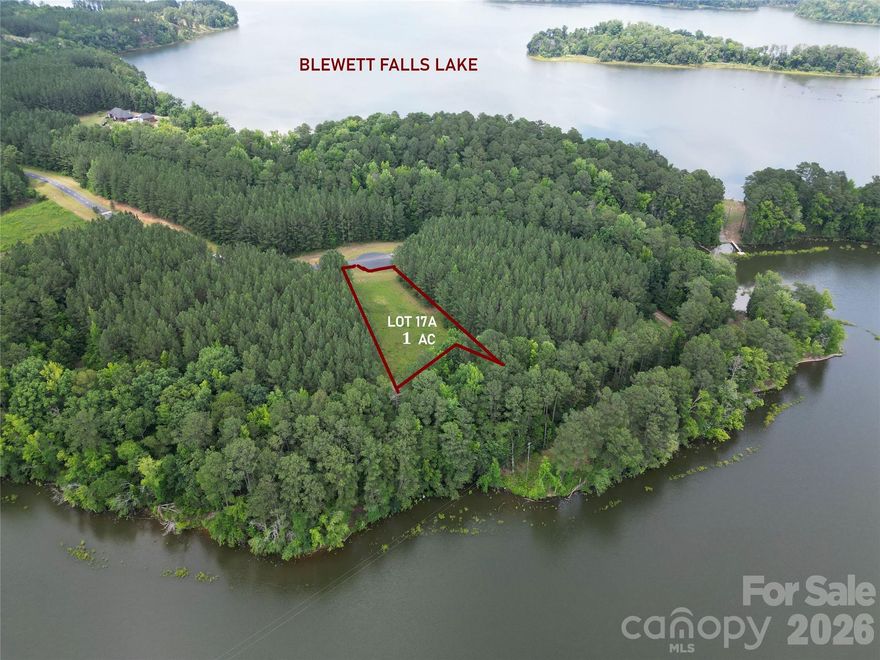 1 ACRE WATERFRONT LOT IN SPENCER POINTE GATED COMMUNITY.  SPECTACULAR SUNSETS OVER THE BLEWETT FALLS LAKE!!!  3 BEDROOM SEPTIC PERMIT VALID UNTIL 1/17/28!   Flat topography and an already cleared lot makes this a Perfect Blank Slate for your Dream House.  Fishing, Kayaking, Canoeing, Swimming and water skiing in a serene natural setting. ONLY $79,000.