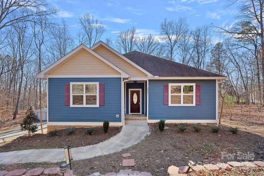 REDUCED! PRICED TO SELL BELOW IT'S TAX VALUE!

Custom Ranch in Stone Mountain – 1 Acre, Cul-de-Sac Lot with Wooded Views

Nestled near the end of a quiet cul-de-sac in Charlotte’s desirable Stone Mountain neighborhood, this beautiful ranch home offers the perfect blend of privacy, craftsmanship, and modern comfort on a full acre of land.

Inside, you’ll find 2035 square feet of open-concept living with three spacious bedrooms and two baths. The thoughtful design features stained woven bamboo flooring, nine-foot ceilings, and no load-bearing walls, creating a flexible and airy flow throughout. The kitchen showcases ash solid wood cabinetry, a Samsung appliance package with a gas range, and a nice walk-in panty—perfect for everyday living and entertaining.

The walkout basement includes a full workshop and provides excellent space for storage, hobbies, or future expansion. A side-load two-car garage adds both convenience and curb appeal.

Additional highlights include a condensing gas furnace, Navien tankless water heater, central vacuum system, and gas/electric laundry hookups. Enjoy quiet mornings or evening gatherings on the wooden back porch overlooking the wooded backyard—a peaceful retreat right at home.

A rare find with quality finishes, thoughtful design, and serene surroundings—this Stone Mountain gem is ready to welcome you home.

Just minutes from 485, access to Charlotte, Harrisburg and Concord is just a short drive!