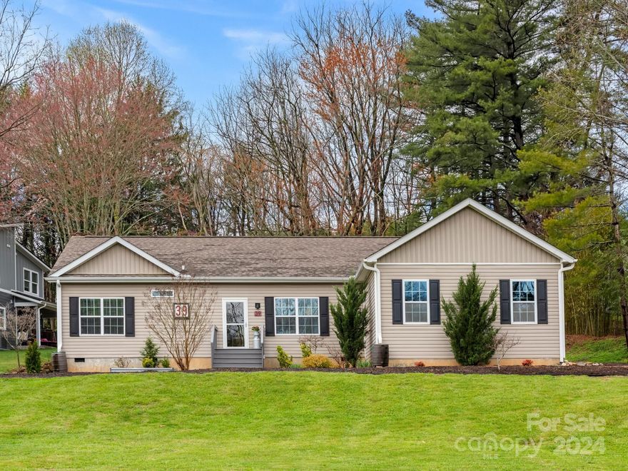 Situated on nearly half an acre, this beautifully maintained ranch was built in 2015 and includes 2 bedrooms plus bonus room w/ closet. The fantastic open floor plan features living room w/ gas logs fireplace and access to large covered back deck. The kitchen is equipped with stainless steel appliances, breakfast bar plus marvelous design and functionality. You'll love the primary bedroom suite w/ large walk-in closet, garden tub, and separate walk-in shower. The garage can easily be converted into a workshop or hobby room. Highlights include RV parking pad, fenced dog lot, lovely landscaping with gorgeous rock features, and appealing touches inside and outside of this well-kept home. Amazing South Asheville location convenient to shops, dining, amenities, interstate, and downtown Asheville!
