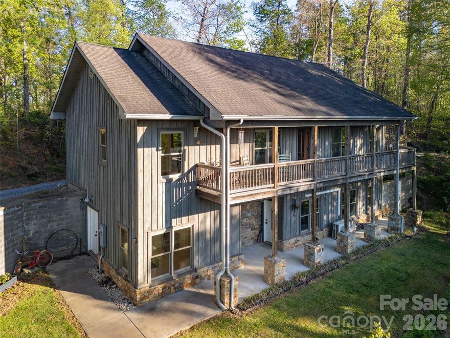 Peaceful, private, tranquil mountain living designed for entertaining and comfortable everyday life. Enjoy mornings and evenings on a covered deck taking in the majestic year-round views. On the main level enjoy natural lighting everywhere you turn. A functional mudroom with tile floor offers you convenience upon entry, hardwood flooring from thereon. The chef's kitchen is a masterpiece of design featuring granite countertops, wooden cabinets, and rubbed bronze fixtures. The upper level is dedicated to rest and retreat!  The primary bedroom bath has a porcelain freestanding tub with a chandelier set by a window to stargaze while bathing. The other two bedrooms have pleasing accents, their own bathroom, and are split from the primary bedroom. Downstairs provides flexibility with a separate entrance to a full private suite featuring LVP flooring, full kitchen, an additional bedroom, a bonus room, abundant storage, and a workshop. The grounds offer space for gardening and play. Conveniently located just minutes from Sylva, Dillsboro and Cherokee with opportunities for recreation, shopping, dining, festivals and concerts.