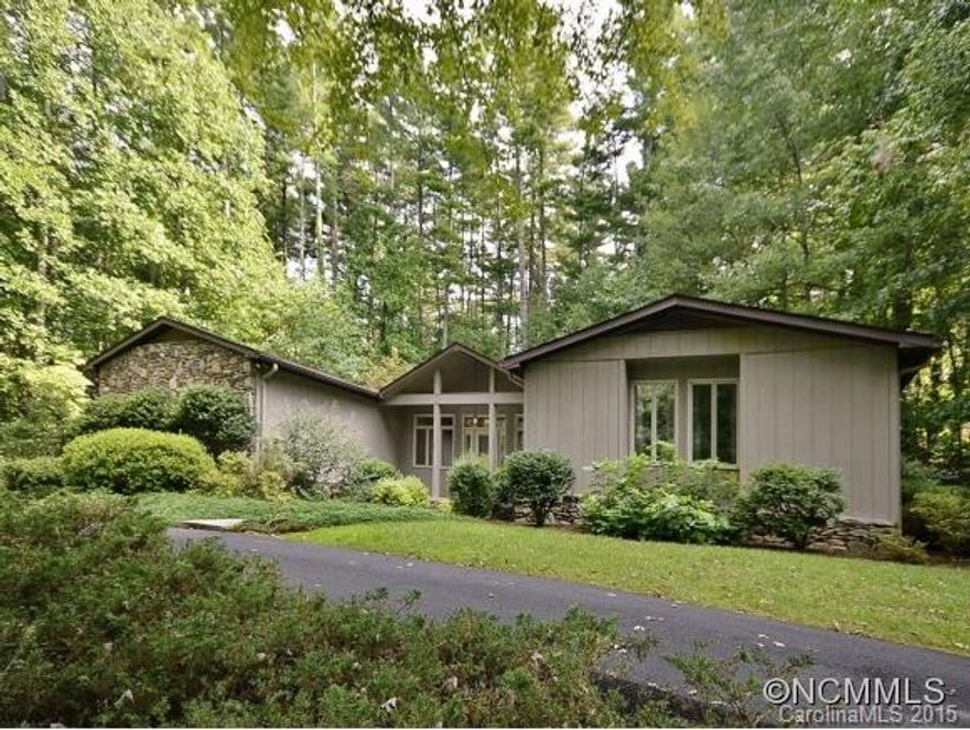FLAT ROCK - Delightful home in private setting. Be greeted by impressive floor-to-ceiling FP as you enter. Lots of windows provide great light for a sunny, cheerful living room. Great kitchen opens to spacious dining room, providing a special place for friendly gatherings. Laundry room and large pantry off kitchen. Well-kept grounds and some sunny spots for gardening.