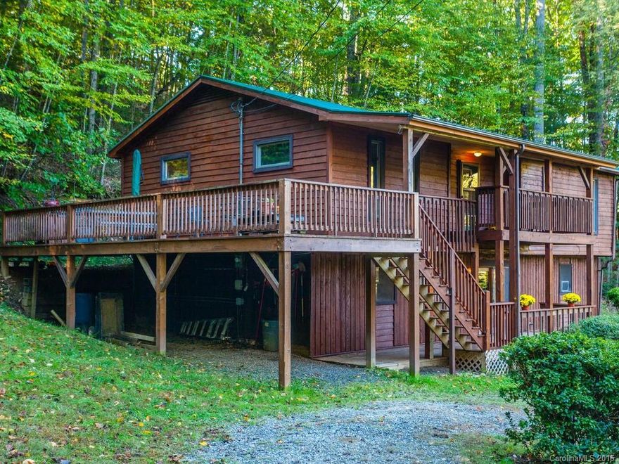 Great value for this square footage! Easy for buyers to update & priced accordingly. Retreat-like setting in the Pisgah Nat'l Forest yet convenient to shopping & amenities by 5 miles. ~900sf outdoor deck space, almost an acre of land w raised bed garden. Renovated in 2011 w metal roof, deck. LL apartment area w separate entrance & FULL kitchen. Beautiful fenced yard to enjoy w a circular driveway. Bonus rooms in lower level. 4 bdrm per tax record. Septic docs not found. Motivated sellers!