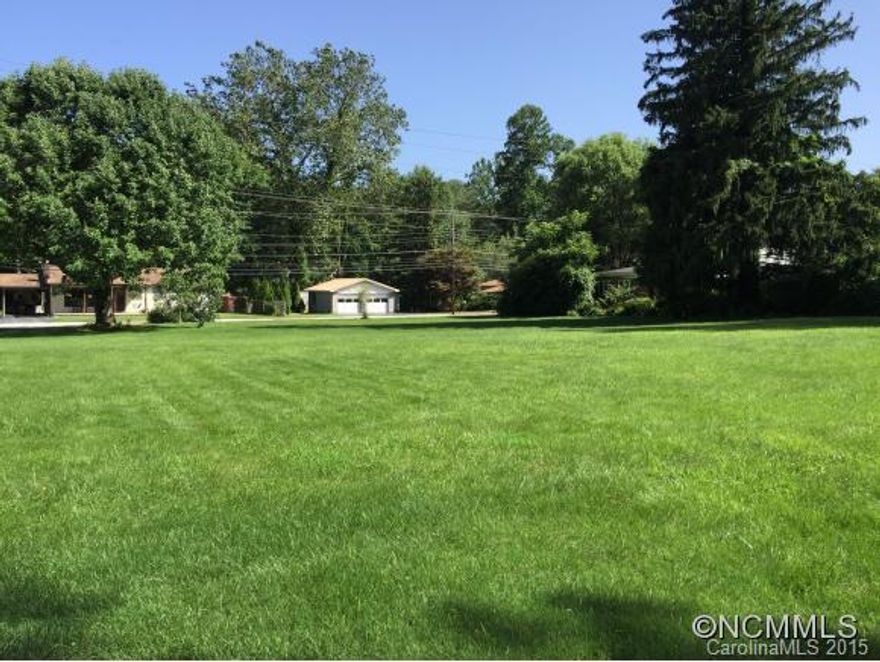 Beautiful, flat lot with lush lawn in popular neighborhood. In Waynesville town limits with city water and city sewer. 100-year flood plain.boundary crosses lowest corner of lot in back.