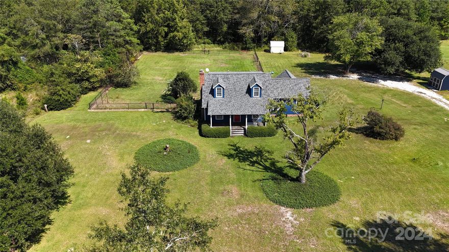 COME SEE THIS CHARMING RUSTIC TWO STORY FARMHOUSE ON A COUNTRYSIDE ENVIROMENT WITH WOOD SIDING. THIS IS A THREE, POSSIBLY FOUR, BEDROOM HOME WITH THREE FULL BATHS. THE MASTER BEDROOM IS ON THE MAIN FLOOR WITH A PRIVATE ENTRANCE. GAS FIREPLACE FOR THE COOLER NIGHTS.  MOST FLOORS ARE WOOD AND VINYL. ENJOY SITTIN ON THE FRONT PORCH DRINKING YOUR MORNING COFFEE IN THE SWING OR ENTERTAINING ON YOUR LARGE BACK SCREENED IN PORCH. THIS HOME HAS A LARGE FENCED IN BACK YARD WITH AN ESTABLISHED PEAR TREE PERFECT FOR MAKING PRESERVES. IT ALSO HAS TWO STORAGE BUILDINGS. THE ROOF AS A HIGH QUALITY, LONG-LASTING AND DURABLE ASPHALT SHINGLES WITH A LIFE SPAN OF 50 YEARS AND A TANKLESS WATER HEATER INSTALLED IN 2021. IT IS ALSO WALKING DISTANCE TO AJ HIGH AND MIDDLE SCHOOLS. THIS HOME HAS BEEN WELL MAINTAINED AND WAITING FOR THE NEXT OWNER.
