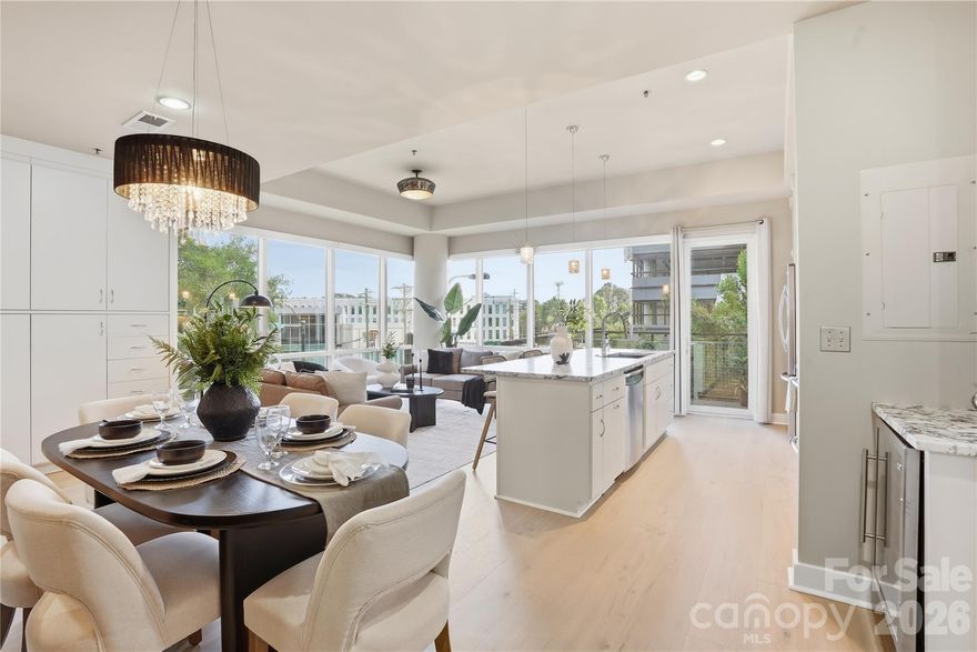 Experience elevated urban living at The Metlofts — one of Charlotte’s most iconic mid-rise communities with breathtaking skyline views. This stunning corner unit features an open floor plan flooded with natural light through wrap-around windows with electric blinds, a chef-inspired kitchen with stainless steel appliances, granite countertops, soft-close drawers, wine refrigerator, and a large island perfect for entertaining. The spacious bedroom offers a private balcony with city views, two large walk-in closets, and a spa-like bath with a walk-in rainfall shower. Building amenities include a rooftop terrace, outdoor pool, and fitness center — all in a fully secured, 24-hour access building steps from Trader Joe’s, dining, and retail. Parking included on the 4th level deck.