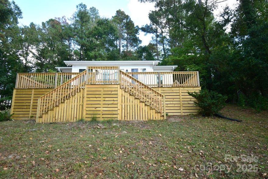 Welcome to this beautifully remodeled two-bedroom, two-bath riverfront home on Lake Wateree that offers the perfect blend of modern comfort and serene waterfront living. Step inside to find an open-concept layout that seamlessly connects the living room, dining area, and kitchen-ideal for entertaining or relaxing with a view. Large windows frame the peaceful lake, filling the space with natural light and showcasing sunsets over the water. The interior features fresh paint, updated flooring, and stylish fixtures throughout. The kitchen boasts sleek countertops and stainless-steel appliances, while both bathrooms have been tastefully updated with contemporary finishes. Outside, a spacious deck invites you to unwind and enjoy the gentle breeze off the lake. Whether you're sipping morning coffee or hosting a weekend gathering, this home offers the perfect spot to take in the beauty of riverfront living. It is a shared driveway with only one other home close to the property and seconds to Hwy 97. There is also boat access and new dock.