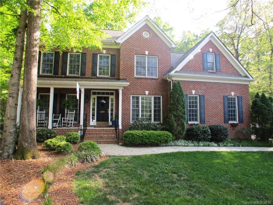 Great 2 story on .58 acre lot w/mature landscaping. Home features rocking chair front porch,gleaming wood floors,formal living & dining rooms, bedroom & full bath on main level great for guests,kitchen has granite counters & large snack bar open to great room w/fireplace & breakfast area,large secondary rooms,huge bonus room & additional office on upper level,wood deck & fenced yard w/playground.Home is across the club house & community pool.Close to shopping,restaurants, schools and lake.