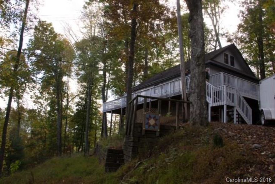 Fantastic mountain VIEWS from tis house with end of road privacy. Wrap around deck with screened in area perfect for entertaining or dining. 2 story house with loft boasts a wonderful great room with stone fireplace with Propane log insert. Soaring windows to allow the view and sun in. Kitchenw ith updates, 2 good sized bedrooms and full bath on main. Loft area has closet and 1/2 bath. Lower level has bonus room and bath, garage and utility room and more space for storage or whatever. Must see!