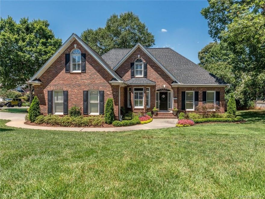 Custom Built with fantastic floor plan! Master on the main along with 3 additional bedrooms. Kitchen features granite countertops, tile backsplash & SS appliances with tons of cabinet storage. Hardwoods in main living areas downstairs including stairs. Tile in all 4 bathrooms. Bonus/loft and 5th BR up with full bath. Plantation shutters & wood blinds. Walk-in attic storage. Tankless WH. Professionally landscaped with mature trees, full irrigation, brick paved patio & beautiful accent lighting.