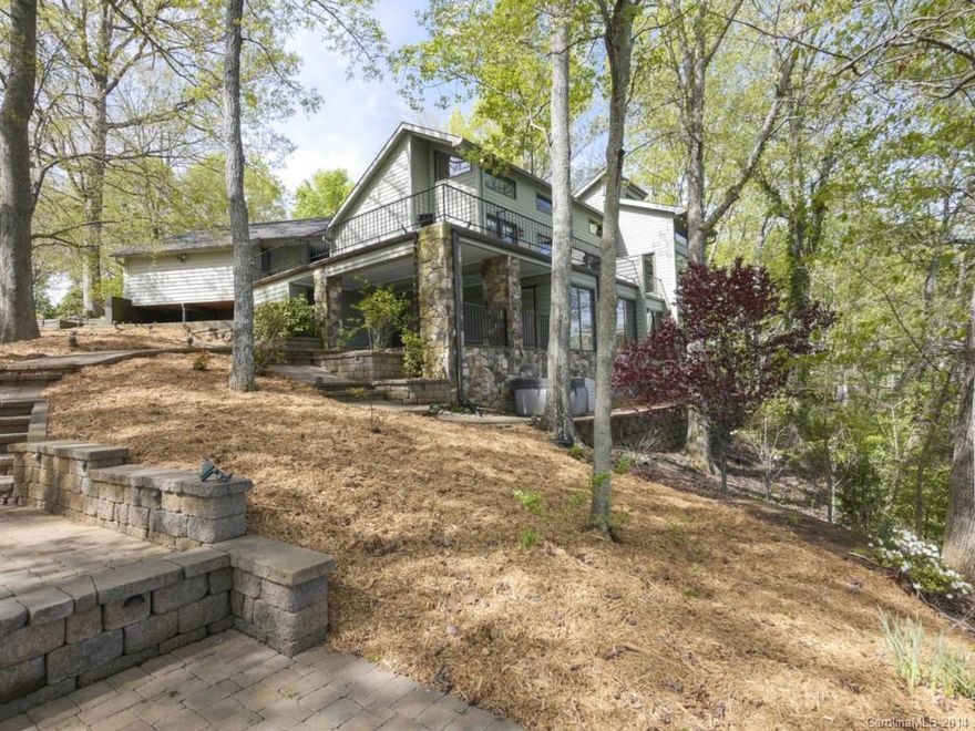 Over $1M invested in this beautiful home and setting- just reduced $85K! 330 Ft. of shoreline awaits you, open to vast, unobstructed water views from most every room, in a beautiful, private park-like setting. A dream kitchen, beautiful HW floors,  private loft/office w/custom built bookcases. One Master Suite w/private WF sitting rm; 2nd Master suite on main; a covered stone terrace;deep water dock, sundeck & fire pit. Finished garage w/separate workshop too! Blueprints available for expansion!