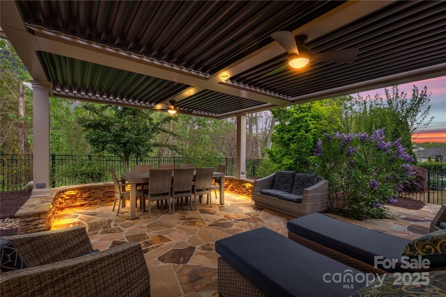 Welcome to 2035 Palace Way, in Indian Land, SC. The home sits on a premium lot with a private wooded backyard. The open-concept design features laminate and tile flooring throughout, elegant crown molding & wainscoting. The spacious living room & sunroom have tinted windows for added comfort, while the gourmet kitchen offers Café built-ins for extra storage and counter space. The laundry room includes a utility sink & folding table. Home also includes a 3 car tandem garage. Outdoor upgrades include a Tennessee Flagstone driveway extension, landscaping, & rear patio, plus an extruded aluminum pergola with motorized slats, ceiling fans, & lighting. Additional features include a whole-house surge protector & a new AC unit. Located conveniently near the new Target & Costco's. Close to shopping, dining & more.
***SELLERS PROVIDING A $5,000 PAINT ALLOWANCE TO BUYER!