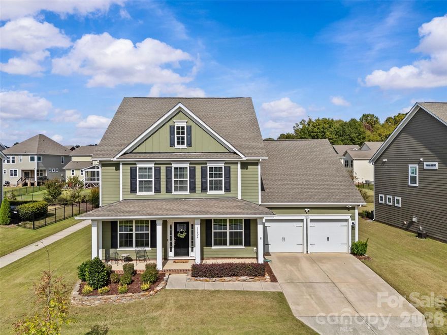 If prime location, top-rated schools and room to grow are on your list of "must-haves" in your new home, then you'll want to give this home a second look!  Located just 2 miles from Main St. in downtown Davidson and only minutes from downtown Cornelius, this stunning 5-bedroom, 4.5-bath home offers over 3,500 SF of functional living space in a picturesque, family-friendly neighborhood with huge community pool, clubhouse, playground, walking trails and so much more!  The open-concept main living area features a home office, formal dining space and a bright, modern kitchen with upgraded appliances, a walk-in pantry and large island with quartz countertops, perfect for family gatherings.  A convenient main-level bedroom with en-suite bath makes this space perfect for guests or multi-generational living.  Step outside to a fully fenced, flat backyard, complete with paver patio and built-in grill, the perfect place to entertain!  If storage is also on your list of must-haves, this home has it in spades; with a massive L-shaped closet on the main level, custom built-in mudroom drop-zone, hanging storage in the garage, and more closets than you can count.  Additional highlights include a premium whole-home Aquasential Non-Backwashing Water Filtration System, sleek epoxied garage floors and a newly installed electric car charging station.  Upstairs, a spacious bonus room offers endless possibilities for a playroom, crafting room, work out room or media space.  A large primary bedroom with en-suite, three generously sized bedrooms, and two full baths, round out the living space.  Don't miss this perfect blend of luxury, functionality, and prime location.  Schedule your showing today!