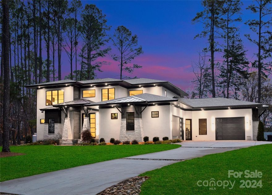 Ask me about 12 month Boat Slip Lease! Award-winning contemporary design home situated on an acre surrounded by Lake Norman views. This incredible builder’s personal home won the 2022 Best of the Lake for New Home Design & is replete with thoughtfully curated design features. Spacious open floor plan is filled with an abundance of natural light. Two story great room with a soaring cypress beamed ceiling & sleek gas fireplace with floating hearth. Stunning kitchen with polished quartzite waterfall island & frameless modern cabinets, beautiful hidden pantry, bourbon bar & glass wine closet. Serene main level primary suite with relaxing soaking tub & curbless tile shower. Generously sized secondary suite and bonus/game room on the second level. Spectacular wide plank white oak hardwood flooring is underfoot in all living areas. Folding slider wall opens the main level to the rear covered porch. Three car attached garage with epoxy floor. Come tour today!