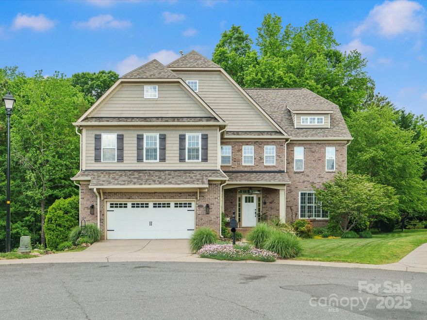 Stylish & impeccably updated, this exquisite home is one of a kind! Five bedrooms each boasting a private en-suite bath, including a main-level BR ideal for guests or office. In every room you'll find tons of natural light, upgraded light fixtures & sconces, plantation shutters. Beautiful hardwood floors throughout main floor, upstairs hallway & primary suite. The gourmet white kitchen impresses w/quartz, gas cooktop, walk-in pantry, butler pantry & seamless flow to the great room w/stone fireplace. Dining room includes a built-in bar & beverage fridge, ideal for entertaining. Enjoy a luxurious primary suite & oversized bonus/6th bedroom. Tankless water heater & roof new 2024. Step outside to a backyard retreat w/Trex deck & awning, a custom patio overlooking swim spa that also functions as a hot tub. Enjoy cascading rock waterfall feature - all on a fenced, wooded lot w/plenty of room to make your own! Nestled on a cul-de-sac just minutes from Ballantyne, Pineville, I-77, & Kingsley.