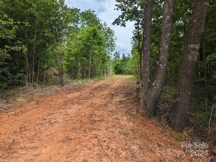 Bring your builder! This property features 2 private acres on Taxahaw Road. The homesite location has been cleared and perced for a 4 bedroom home and is in the much sought after Buford school district. It is zoned rural residential which allows manufactured homes. One acre is cleared and the remaining acre is wooded. This property also has a new survey and county water is available. If you need a builder, we can help with that as well. Come view and envision your beautiful DREAM HOME!