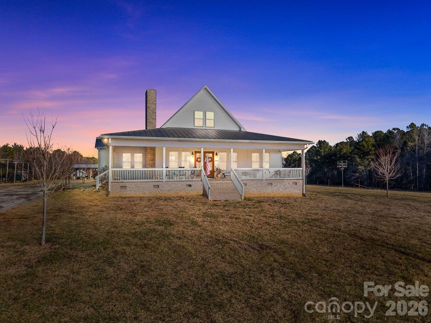 Welcome to your dream country retreat, perfectly situated on over 8 picturesque acres & designed for those who crave space, comfort, & endless possibilities. This outdoorsman’s paradise offers an impressive array of outbuildings including a pole barn, barn with stalls, three log buildings, and a private basketball court. Built in 2018, the beautiful home features 2,794 square feet with a desirable split-bedroom floor plan and open-concept design. Step inside through gorgeous double front doors to find a spacious family room anchored by a cozy fireplace, seamlessly flowing into the dining area and oversized kitchen. The kitchen is a showstopper with a large center island, farmhouse sink, sparkling cabinetry, electric range, and custom hood vent—perfect for everyday living. The home offers 3 bedrooms, 2.5 bathrooms, plus a bonus loft room for added flexibility. The primary suite is a true retreat, featuring a double vanity, tiled walk-in shower, soaking tub, and a walk-in closet. Two generously sized guest bedrooms share a spacious guest bath. Enjoy peaceful mornings on the covered front porch or unwind in the evenings on the screened-in back porch, taking in the serene views of your expansive property. With endless storage and room to roam, this one-of-a-kind property blends modern comfort with country living at its finest.