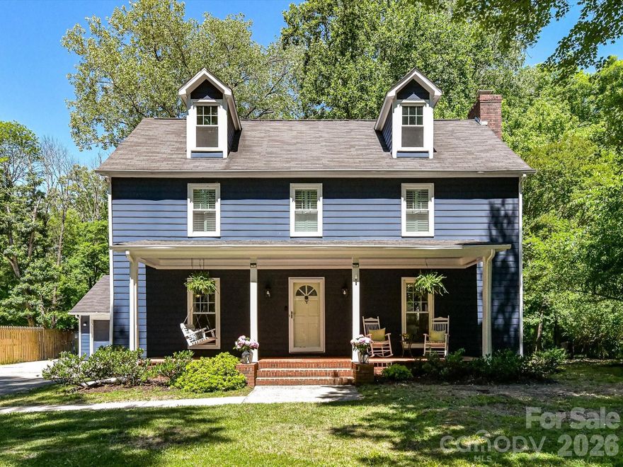 Relax on one of FOUR covered porches in this handsome South Charlotte home designed for exceptional indoor and outdoor living! The beautifully updated Kitchen features quartz countertops, new cabinetry, a stylish tile backsplash, apron-front sink, a chrome chandelier and abundant charm. Adjacent Family Room showcases a new designer light fixture and a cozy wood-burning fireplace with a white brick surround, creating the perfect gathering space.  The dining room features chair rail and a new glass chandelier.  Upstairs, the spacious Primary Suite offers a ceiling fan, charming barn doors leading to the bath, and private access to a covered screened balcony — an ideal retreat for morning coffee or evening relaxation. Primary Bath features dual sinks, a large walk-in closet, private water closet/shower area & plantation shutters. In this bath, you'll also find a staircase to attic storage! Engineered & real hardwoods and tile flooring flow throughout the home for both style and durability. Additional updates include new windows in 2022 (excluding garage,) a new HVAC system in 2025 and brand new hot water heater (May 2026.)   Step outside to your own private sanctuary — a rare .43-acre backyard canopied by mature hardwoods and backing directly to permanently protected parkland that can never be developed. Privacy and green space like this are unmatched at this price point in Charlotte! In addition to the covered porches, you can also enjoy the outdoors or host a large party on the paver patio or around the fire pit.  A detached two-car garage adds convenience and extra storage. in sought-after Sturnbridge, a hidden gem in South Charlotte, residents enjoy sidewalks, street lights, a playground, picnic area, recreation area and tennis/pickleball courts and this home is located just steps from the park.  Incredible location just minutes to SouthPark, Ballantyne, I-485, dining, shopping and everyday conveniences!