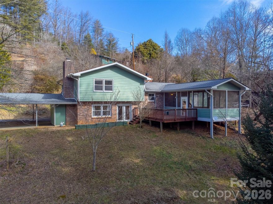 Located just minutes to Western Carolina University, this home offers the perfect blend of convenience, comfort, and mountain charm! Thoughtful updates over the past few years include a newer roof, gutters, durable cement board siding, and a large screened porch, an ideal spot to relax with morning coffee, unwind after class, or entertaining friends! Inside, you'll find 3 bedrooms and 2 bathrooms, a kitchen designed for entertaining with updated concrete countertops and two living rooms—one on the main level and a lower-level living area anchored by a striking rock wall fireplace. Outside, you'll find a detached storage room, a two-car carport with built-in storage and enough space for a small garden. All this in the desirable Village of Forest Hills—just under a mile from WCU and 10 minutes to downtown Sylva!