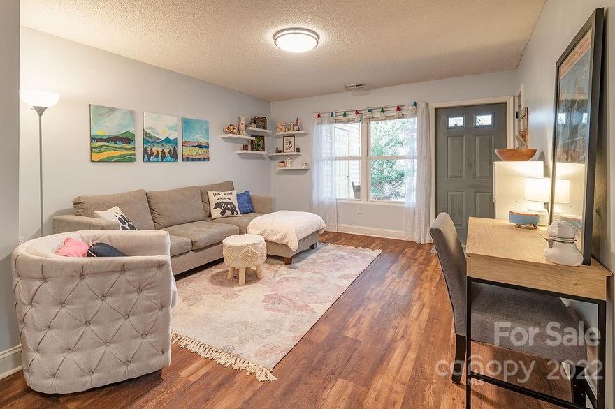 Affordable one-level condo in a quiet, convenient neighborhood near Biltmore Lake features an open floorplan and new flooring throughout. No stairs; park in lot then take the ramped sidewalk to the rear lower level lined with mature trees in a lovely, peaceful setting. Two generously sized bedrooms, new bathroom vanity, new blinds and light fixtures, and kitchen updated with new counters and backsplash. Partially covered private patio with storage closet. Two pets up to total of 50 lbs. allowed. Only 20 minutes to downtown Asheville! HOA covers: water, community septic sewer, trash, lawncare, snow removal, and exterior maintenance. Why rent when you can live comfortably and build equity in your own home? Won't last long--arrange a showing asap!