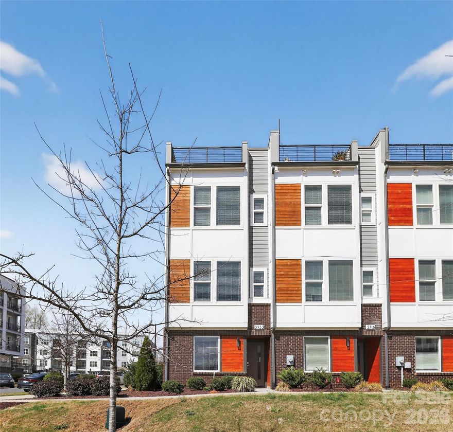 Immaculate end unit townhome with a rooftop terrace that boost an amazing view of the city. Ideally located in vibrant FreeMoreWest neighborhood adjacent to Legion Brewery. This community is within walking distance of tons of restaurants and shops and just 1 mile from beautiful Uptown Charlotte. Take your bike out or go for a run on the Stewart and Irwin Creek greenways and enjoy easy access to major highways. This home features built in kitchen seating, upscale appointments, including plank hardwood floors throughout, oak tread staircases, upgraded quartz countertops, subway tile backsplash, stainless steel appliances including refrigerator, washer/dryer and blinds. Upgraded pantry and half bathroom with epoxy floors in the garage. This community also features a dog park for your furry friends! This opportunity to own an end unit town home with an amazing city view will not last long.