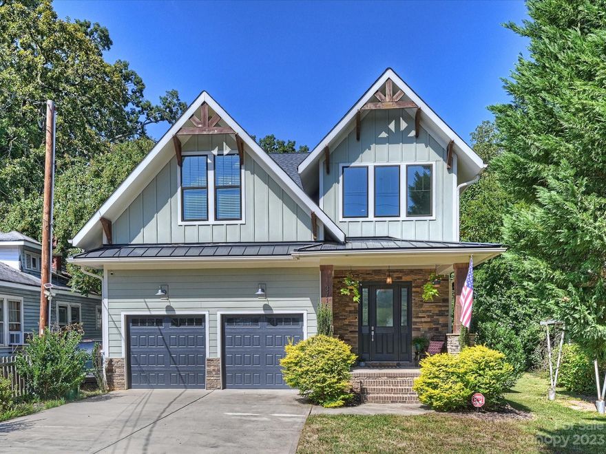 Welcome to this NoDa/Arts District charmer close to the light rail, shopping, dining & numerous hot spots in the city! Built in 2017, this bright, open floor plan home is move in ready! A rocking chair front porch, clad in pre-cast stone, welcomes you & leads you into the beautiful, light-filled, 2-story foyer & great room with exposed beams & floor to ceiling stone fireplace. Kitchen includes stainless appliances, sparkling countertops & an island with ample seating. Laundry room with built-in drop zone. Half bath off the great room for convenience when entertaining guests. Large primary suite on main floor with barn door leading to en suite bathroom featuring dual vanities & tile shower. 2 additional bathrooms & 3 more bedrooms on 2nd floor. Fenced in back yard & tons of room for relaxing on your covered porches off the front & back of this marvelous home! Showings begin Friday, October 6th. Inspection report from 2022 is available.